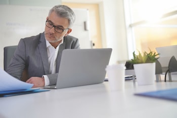 Businessman in office working on laptop